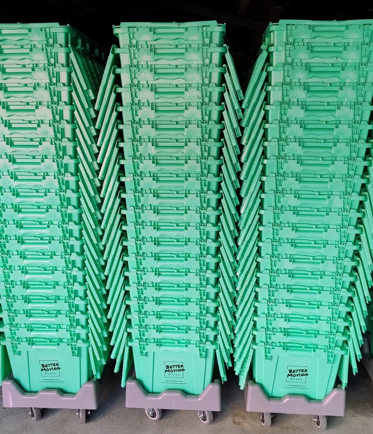 Moving crates stacked on wheeled dollies